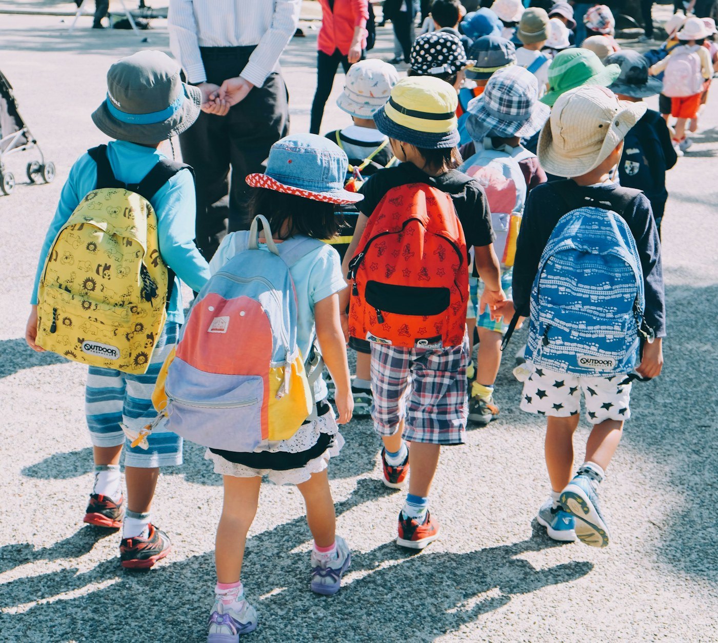 Young children walking together with backpacks